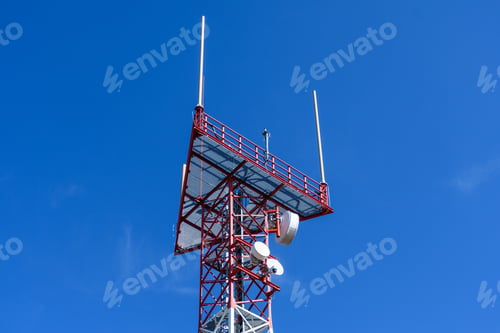Preview: Low angle view of Metal construction of a radio tower against a blue sky