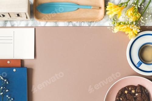 Preview: High angle of desk with flowers, coffee cup, notebooks and copy