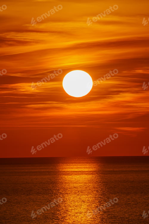 Preview: Fantastic sunset over ocean. The sun goes down over the sea. Dramatic Sunset Sky