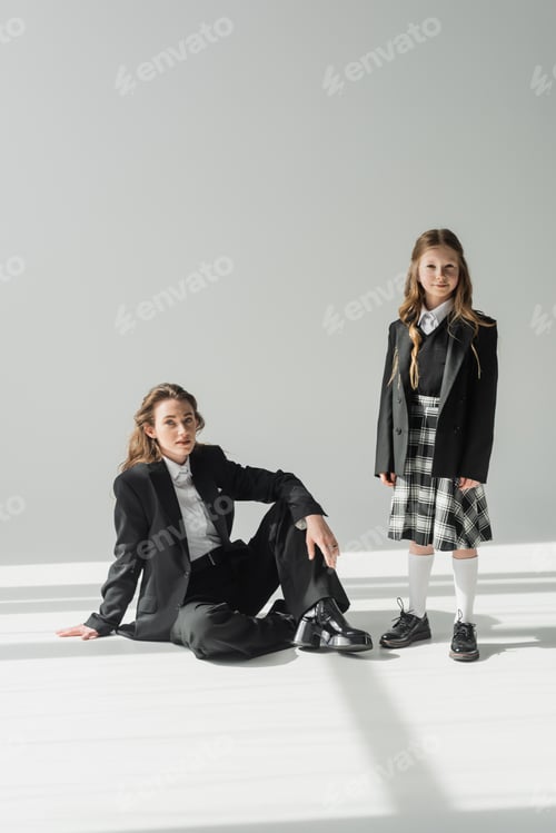 Preview: working mother and child, businesswoman in suit sitting near schoolgirl in uniform