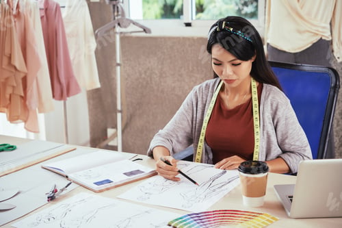 Preview: Asian tailor sketching at work