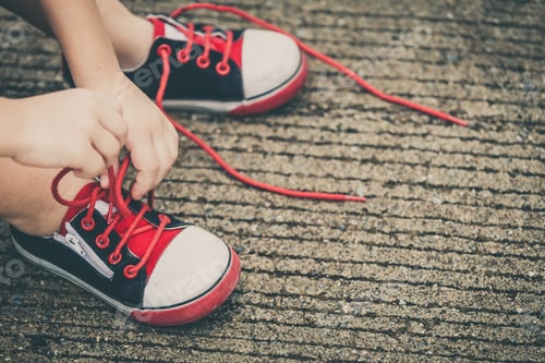 Preview: youth sneakers on boy legs on road