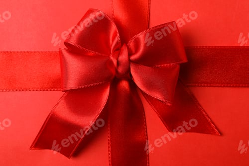 Preview: Red bow on red background, close up