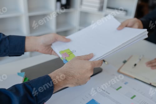 Preview: Businesspeople hands working in stacks of paper files for searching, business employee working in st