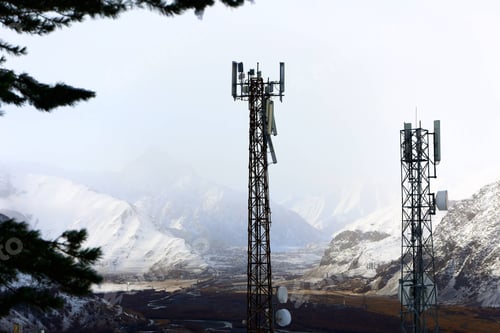 Preview: A pair of communication towers amidst a scenic mountain range in Georgia, Stepantsminda