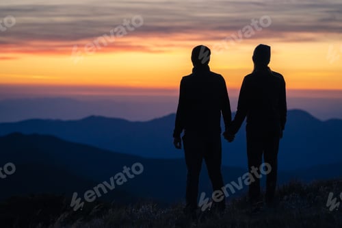 Preview: The silhouette of the couple on the mountain with a sunset background