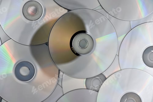 Preview: Lots of used laser CDs and DVDs on the surface of the table