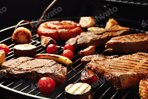 Preview: Fresh grilled meat steaks and vegetables on barbecue grate
