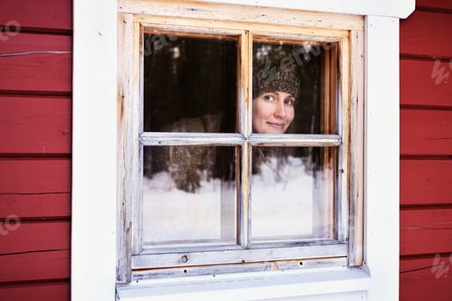 Preview: Portrait of young woman peering out of cabin window, Posio, Lapland, Finland