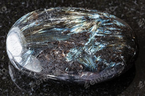 Preview: sample of polished nuummite rock on black granite