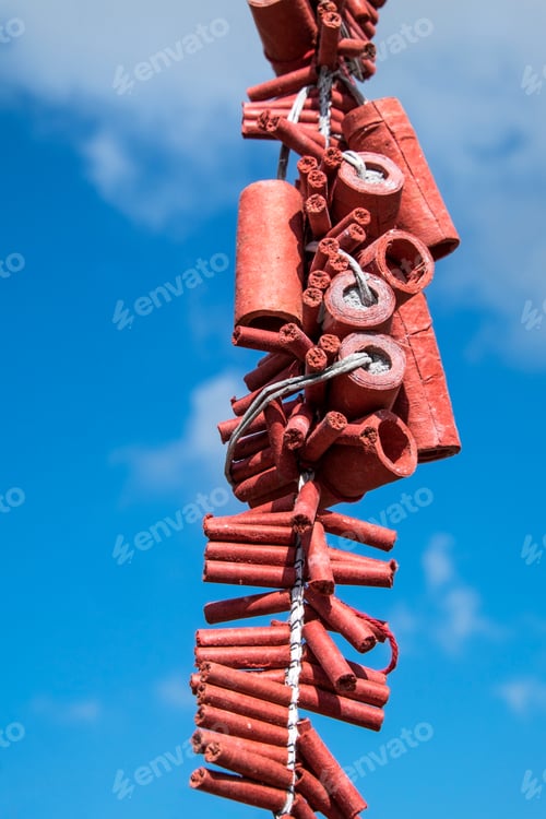 Preview: Close-up of Chinese New Year firecrackers against blue sky