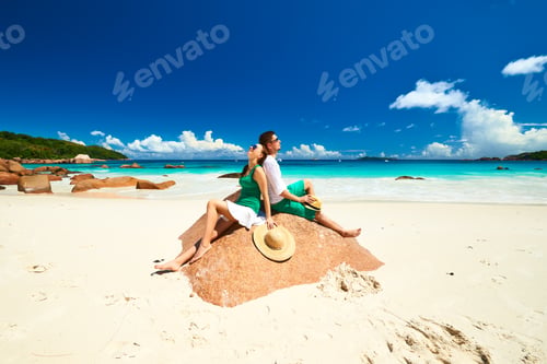 Preview: Couple In Green On A Tropical Beach At Seychelles