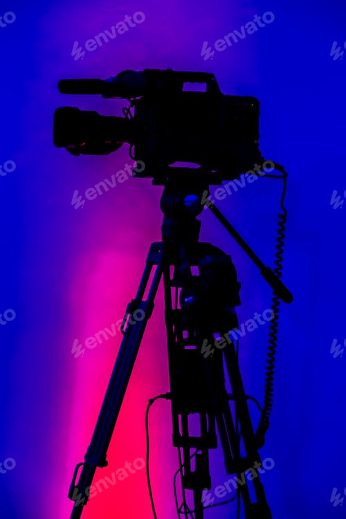 Preview: Vertical shot of a videography camera with a colorful background
