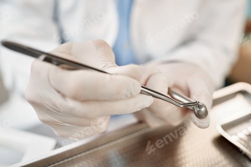 Preview: Close-up of dentist's preparing dental tool while working at his office.