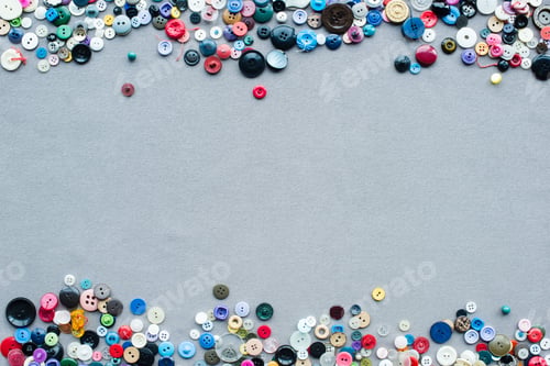 Preview: top view of colorful buttons frame on grey cloth background