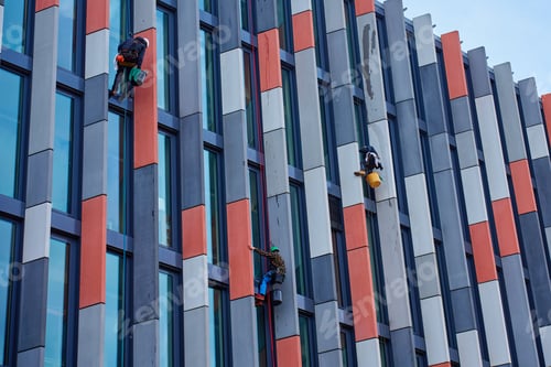 Preview: High rise workers cleaning windows on modern building facade