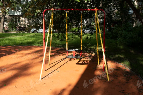 Preview: Baby swings at a playground on a sunny summer day in the city park