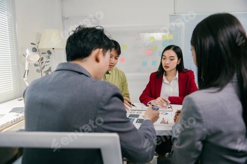 Preview: Business people analyzing charts during corporate meeting