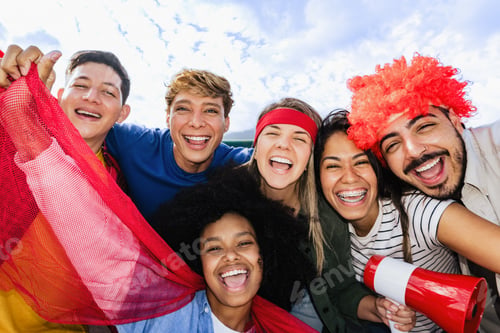 Preview: Red soccer football fans taking selfie at stadium - Diverse supporters cheering championship match