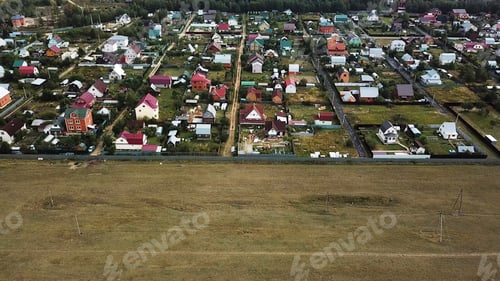 Preview: Aerial view o beautiful small cottages located by the forest and the green field, ecology concept