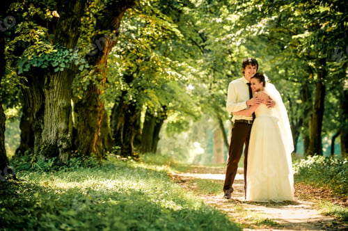 Preview: happy bride and groom on a walk in beautiful forest