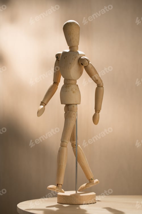 Preview: An artist wooden mannequin stands poised.