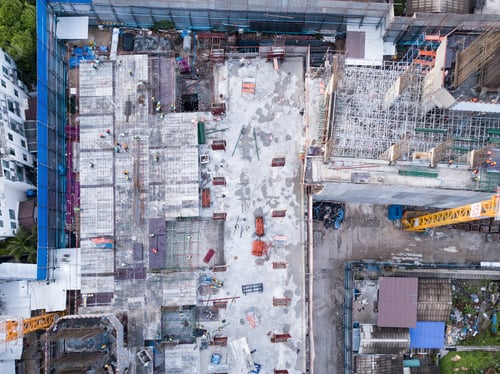 Preview: Aerial view of busy industrial construction site workers working. Development high rise building.