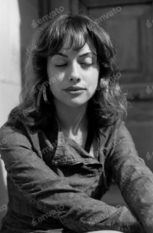 Preview: Monochrome portrait of young woman enjoying sunlight.