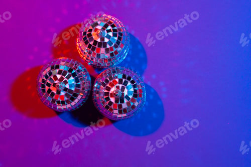 Preview: disco ball shines on purple background close up