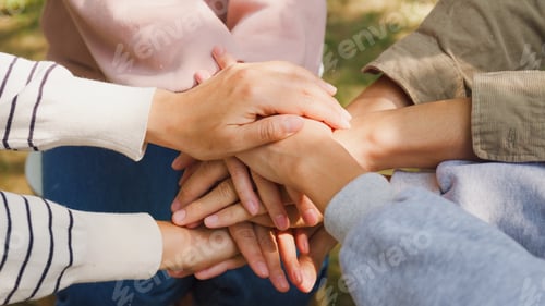 Preview: Group sit in circle hold hands together hope for help people in park.