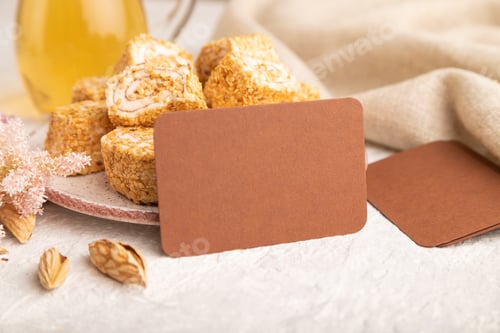 Preview: Brown business card with traditional turkish delight (rahat lokum) on white ceramic bowl on a gray c