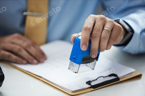 Preview: Male Clerk Stamping Documents in Bank Office Setting