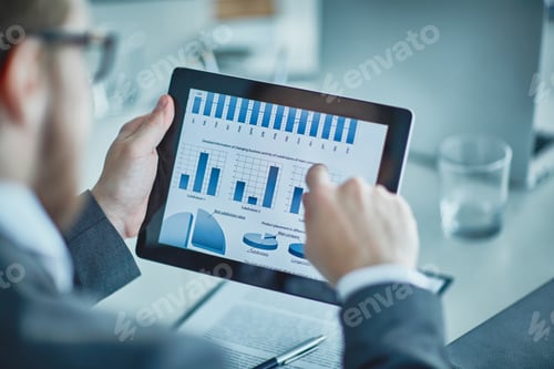 Business Professional Analyzing Charts on a Tablet