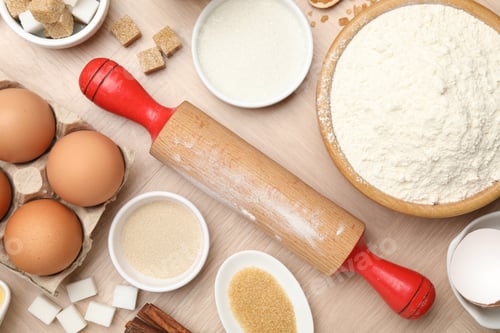 Preview: Rolling pin and different ingredients on wooden table, flat lay