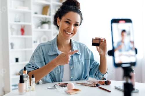 Preview: Lady Blogger Showing Makeup Product To Phone Making Video Indoor