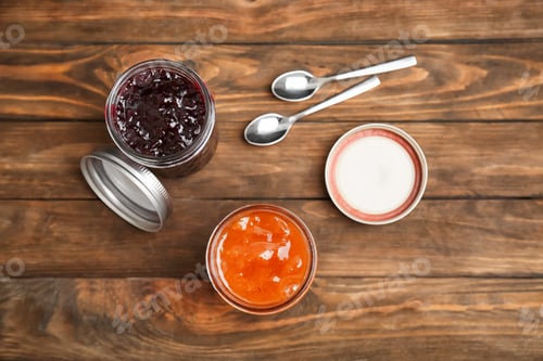 Preview: Two jars with tasty sweet jam on wooden table