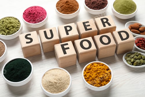 Preview: Different superfood powders and words made of cubes on white table, closeup