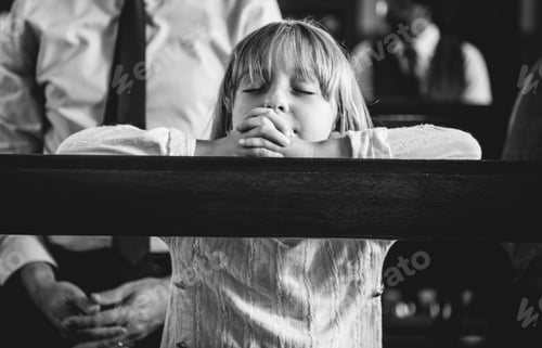 Preview: A child praying inside the church