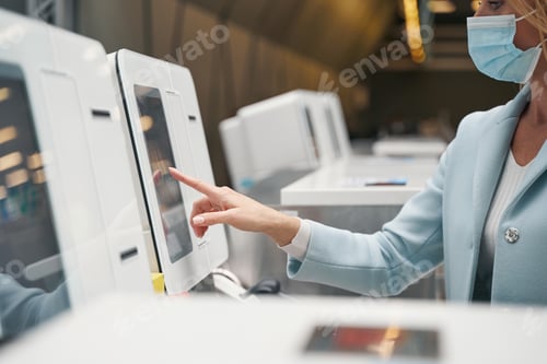 Preview: Focused serious female passenger checking in for flight