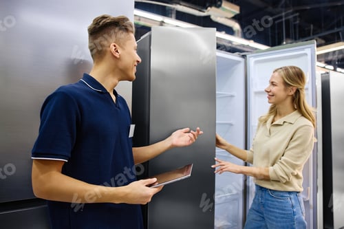 Preview: Engaging Customer Service: Young Salesperson Assisting Shopper in Appliance Store