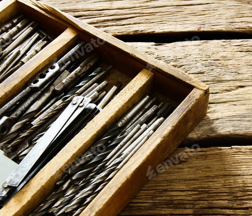 Preview: box with drills on a wooden background.