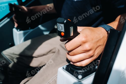 Preview: Close up of a hand holding the control stick and ready to work in the truck crane the largest truck