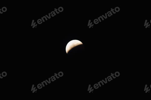 Preview: Sun covering half the moon during a solar eclipse.