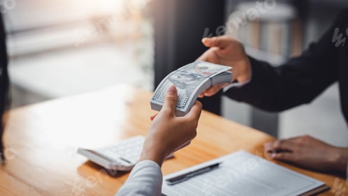 Preview: Financial Transaction with Stack of Money in Workplace