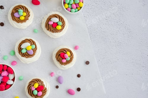 Preview: Mini Pavlova Birds Nest with chocolate cream and colored candy. Food idea for kids. Easter cake.