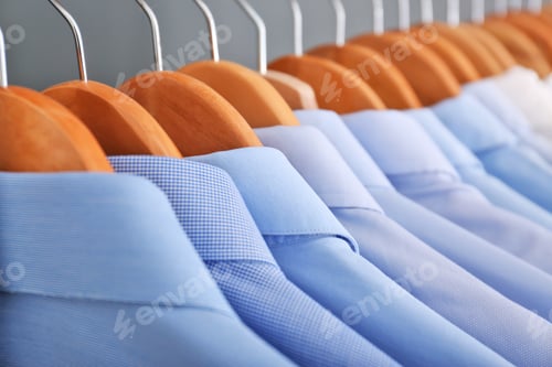 Preview: Clean clothes on hangers after dry-cleaning, closeup