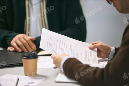 Preview: Middle Aged Caucasian Men Discussing Business Documents during Meeting