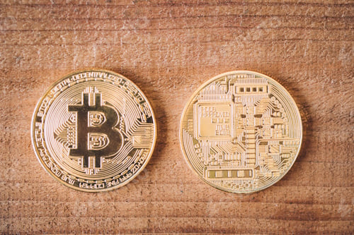 Preview: both front and back of cryptocurrency coins on wooden background