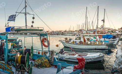 Preview: Serene harbor at dusk with boats moored and calm waters.