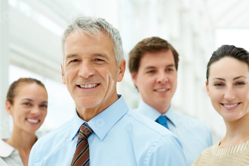 Preview: Confident business man with colleagues in the background